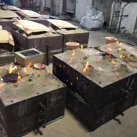 Pouring into each sand casting mold