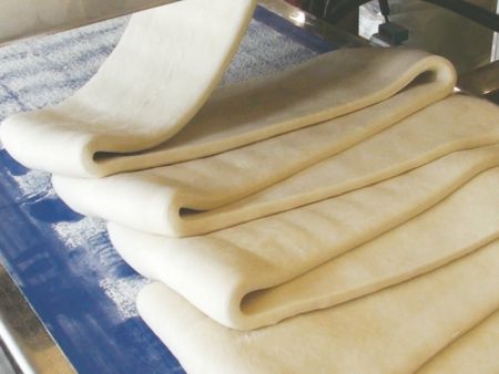 ANKO’s LP-3001 Automatic Layer Paratha Production Line piles the dough sheet on the conveyor belt