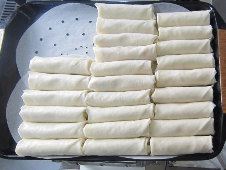 After Spring Rolls are wrapped, they can be sorted manually, or transported for freezing or deep frying