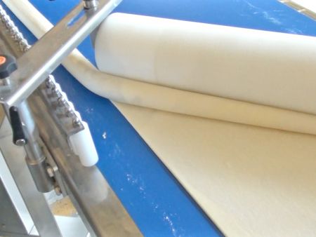 Dough sheet rolls are formed into a long cylinder