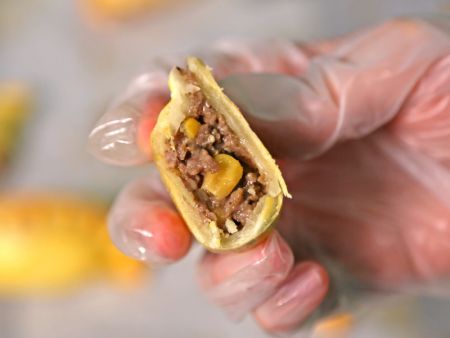 Empanadas are stuffed with ingredients including whole corn kernels