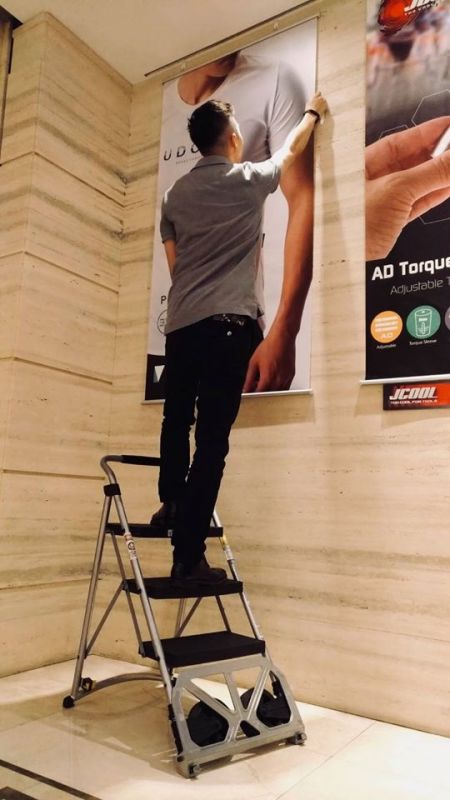 application case study, use as step ladder to hang poster at shop store
