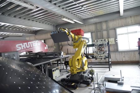 Robot to feed raw material to the punching machine.