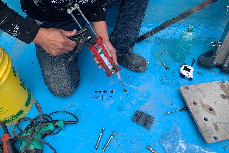 Inject chemical anchor into drilled hole by caulking gun
