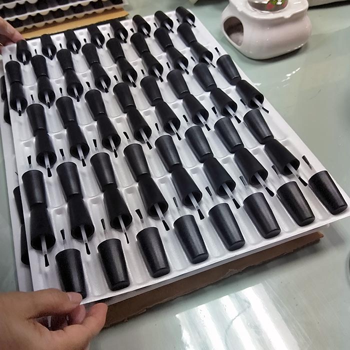 Assembled caps & brushes on trays