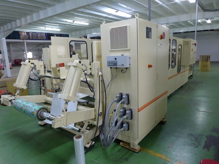 Fully automatic converting machine to make small roll of gift wrapping paper.