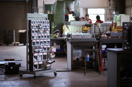 Mobile stand with ABS drawers for industrial storage.